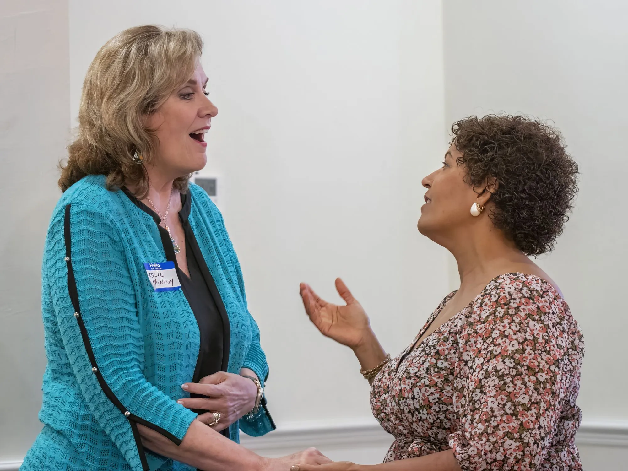 Two women in conversation during a break