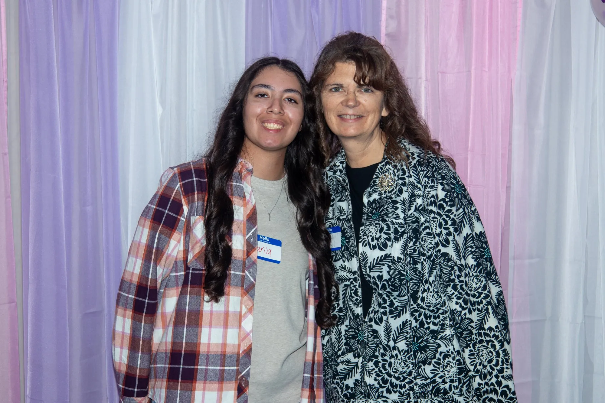Two women arriving together at the backdrop