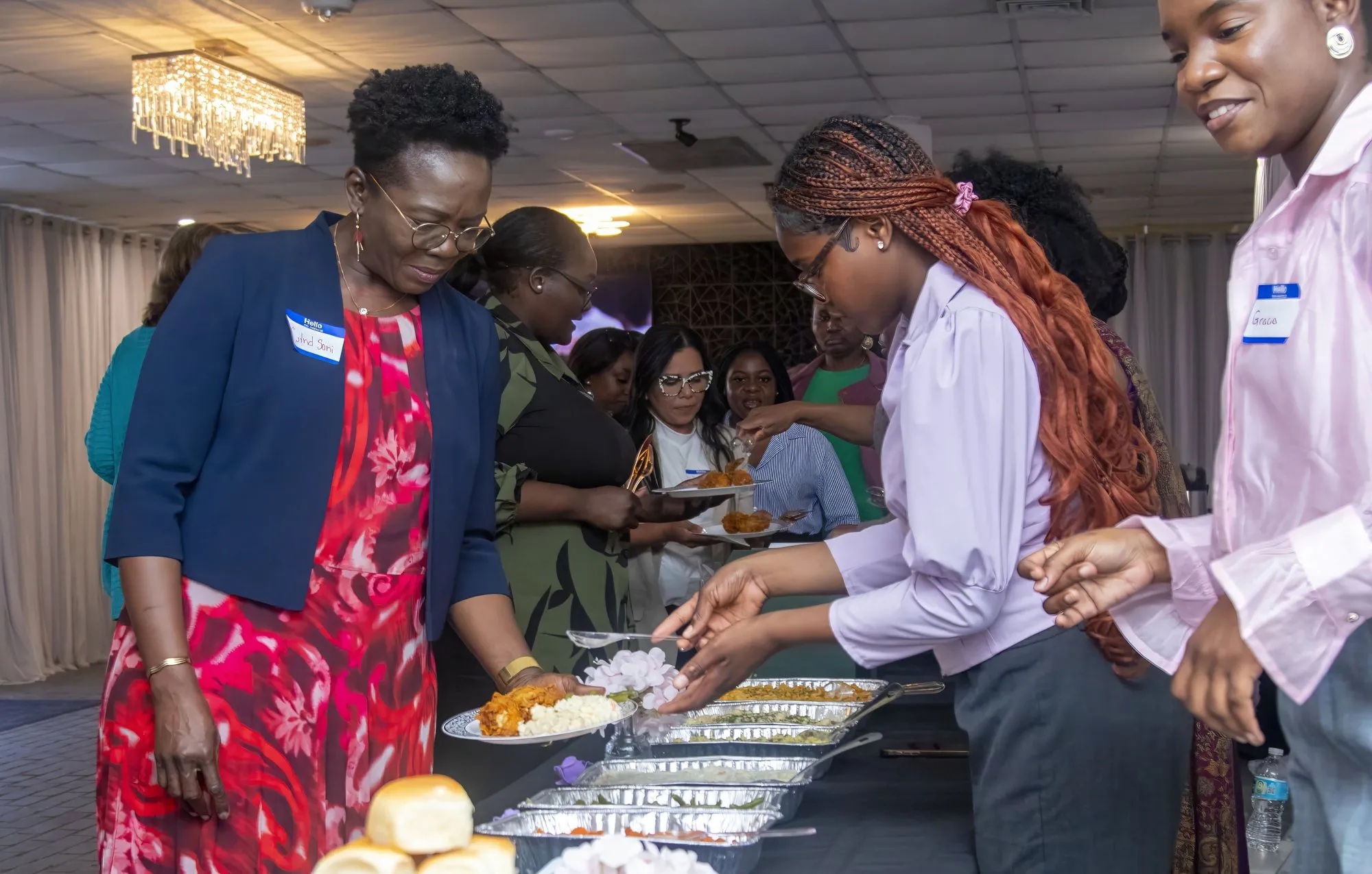 Women serving themselves at the buffet