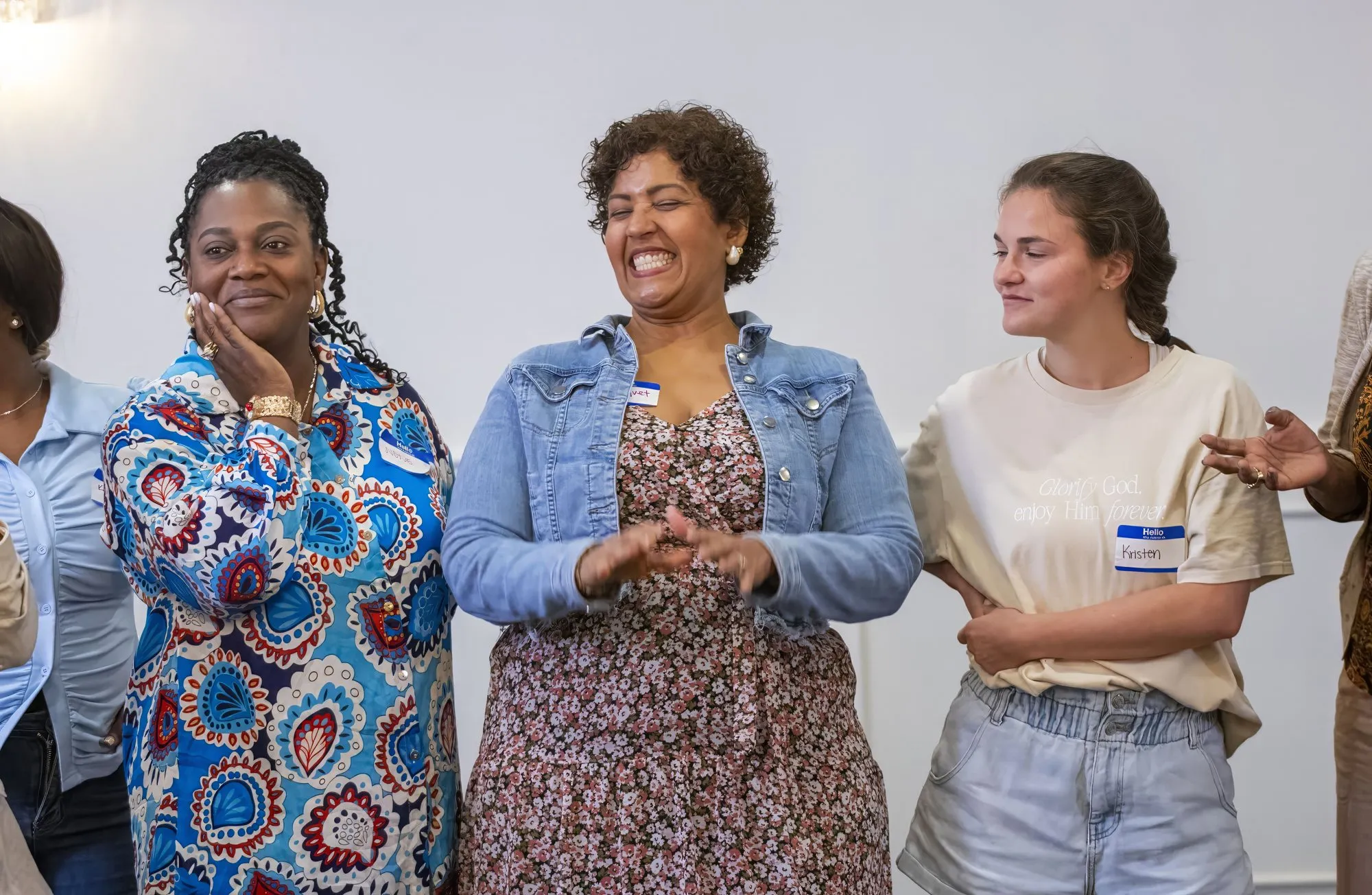 Three women standing together, smiling