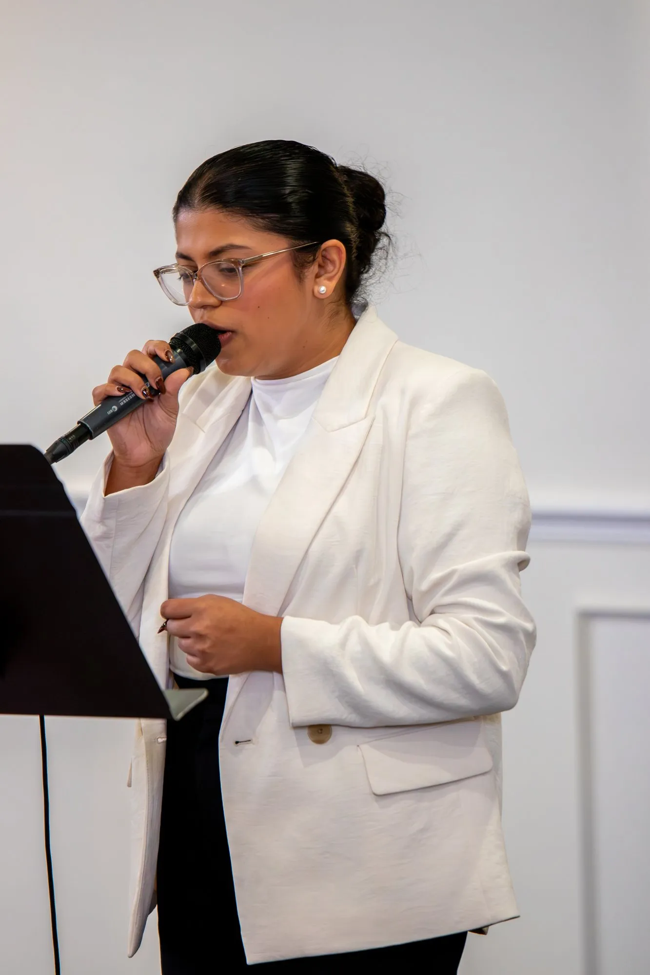 A young woman speaking at the microphone