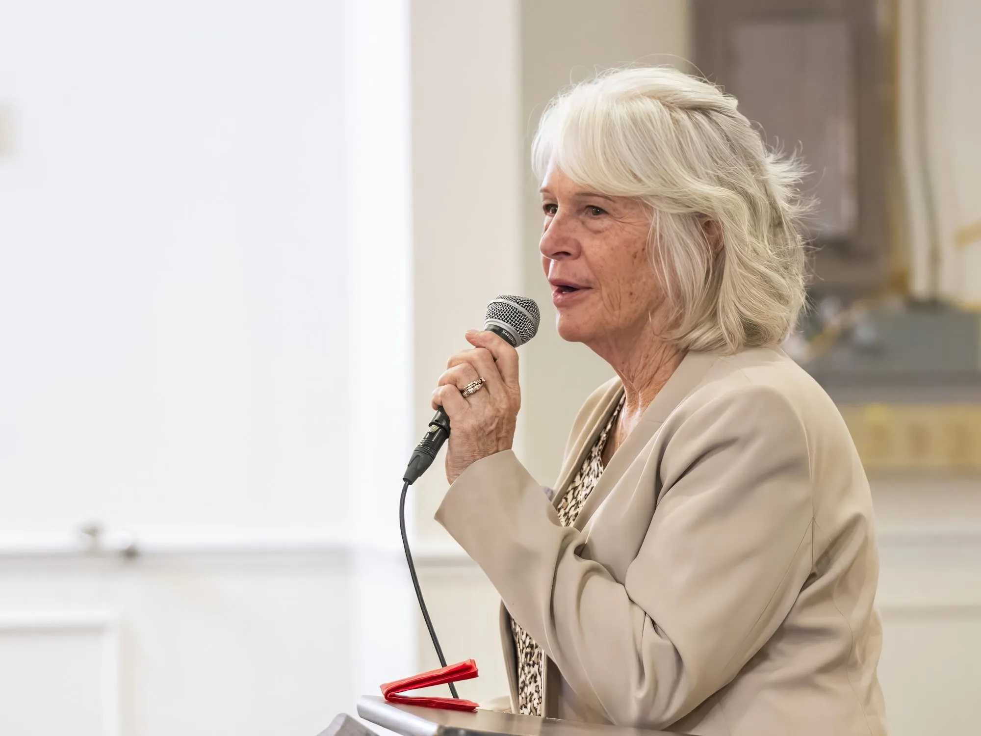 A woman sharing at the microphone