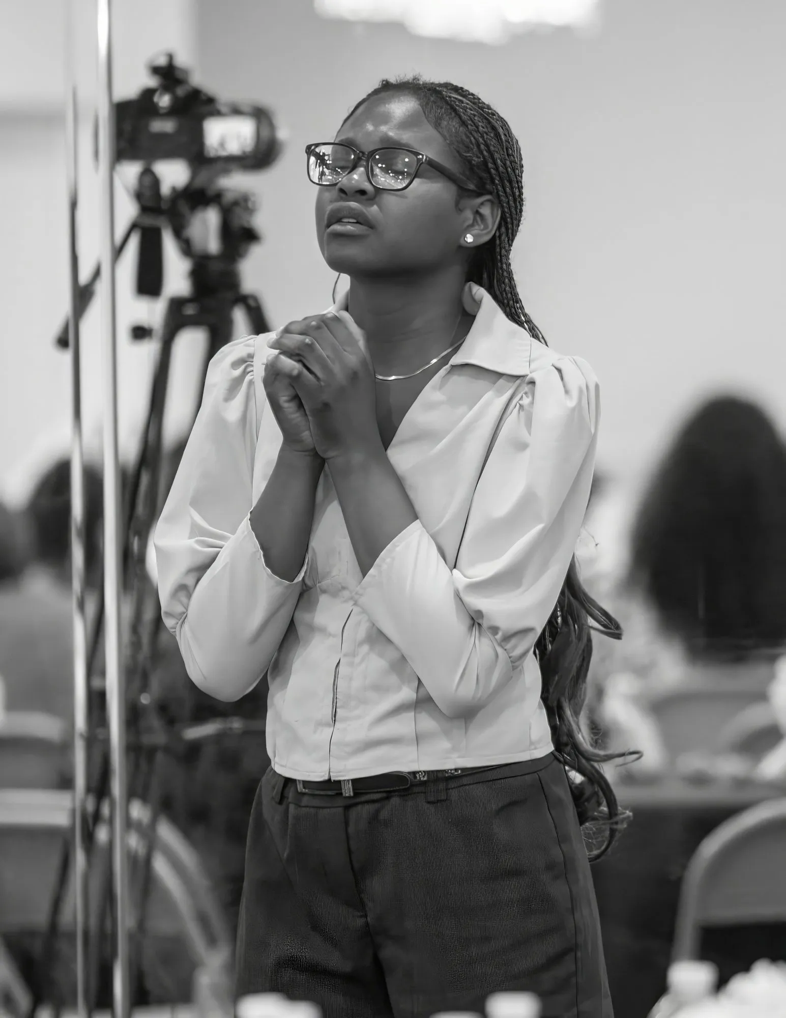 A woman praying quietly during the service
