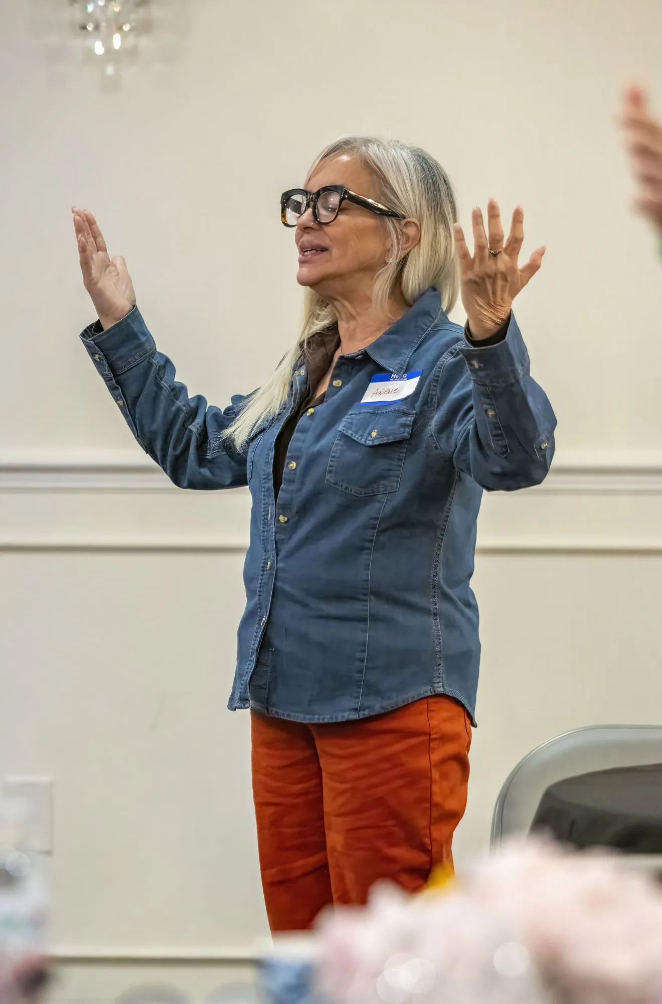 A woman worshipping with both hands raised