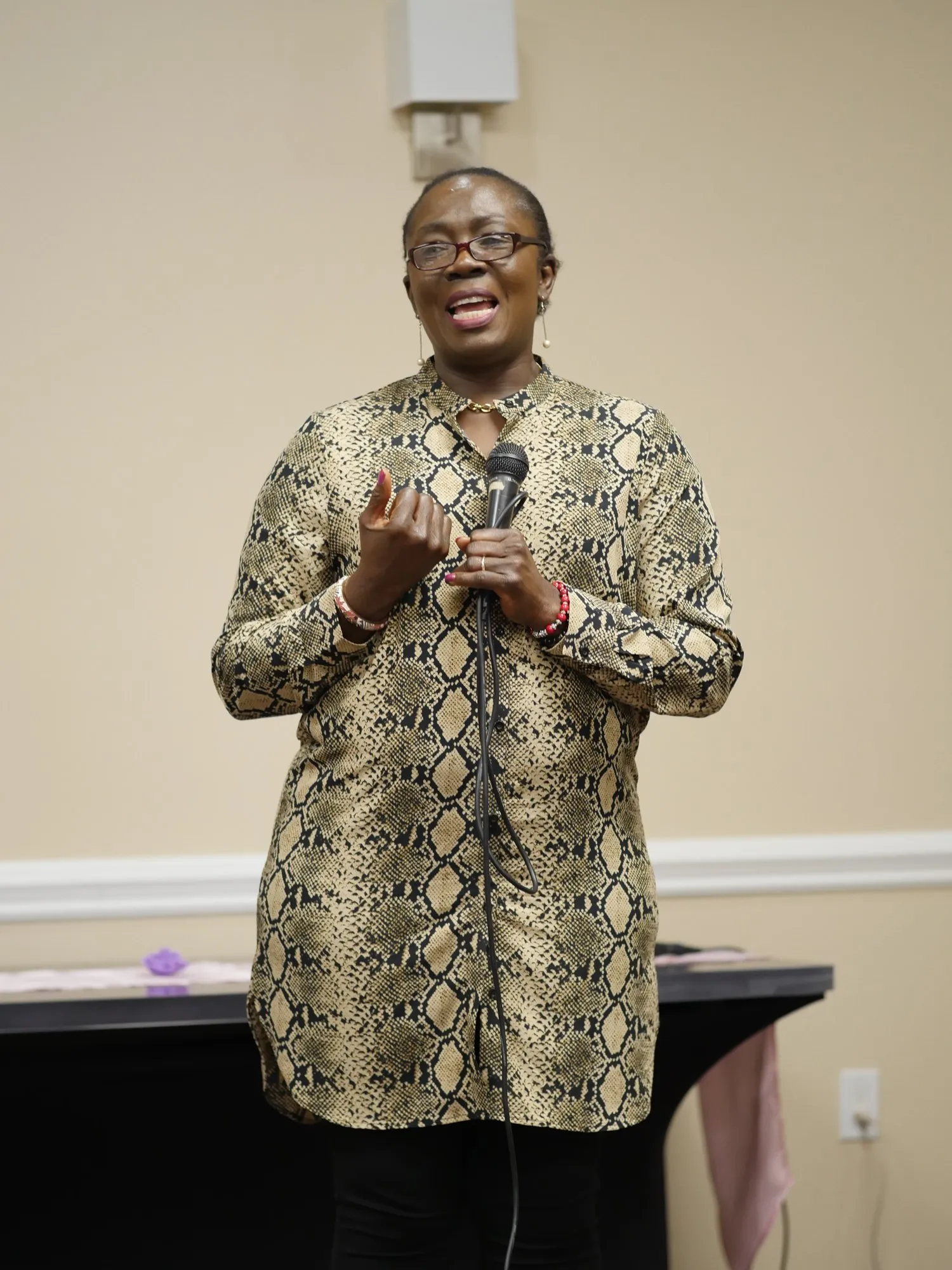 Pastor Astrid Soni speaking at the microphone in 2020