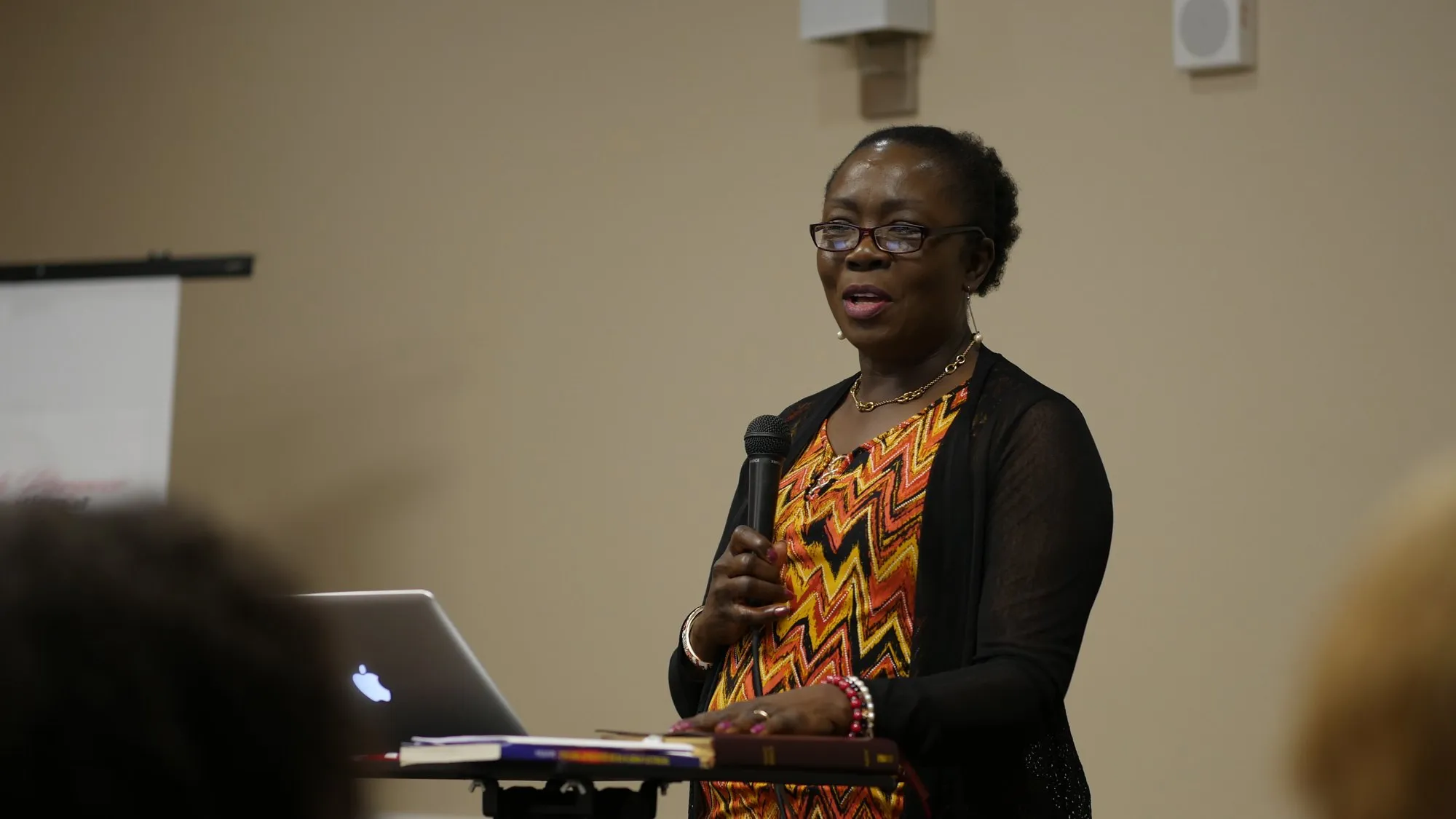 Pastor Astrid Soni teaching from her notes in 2020