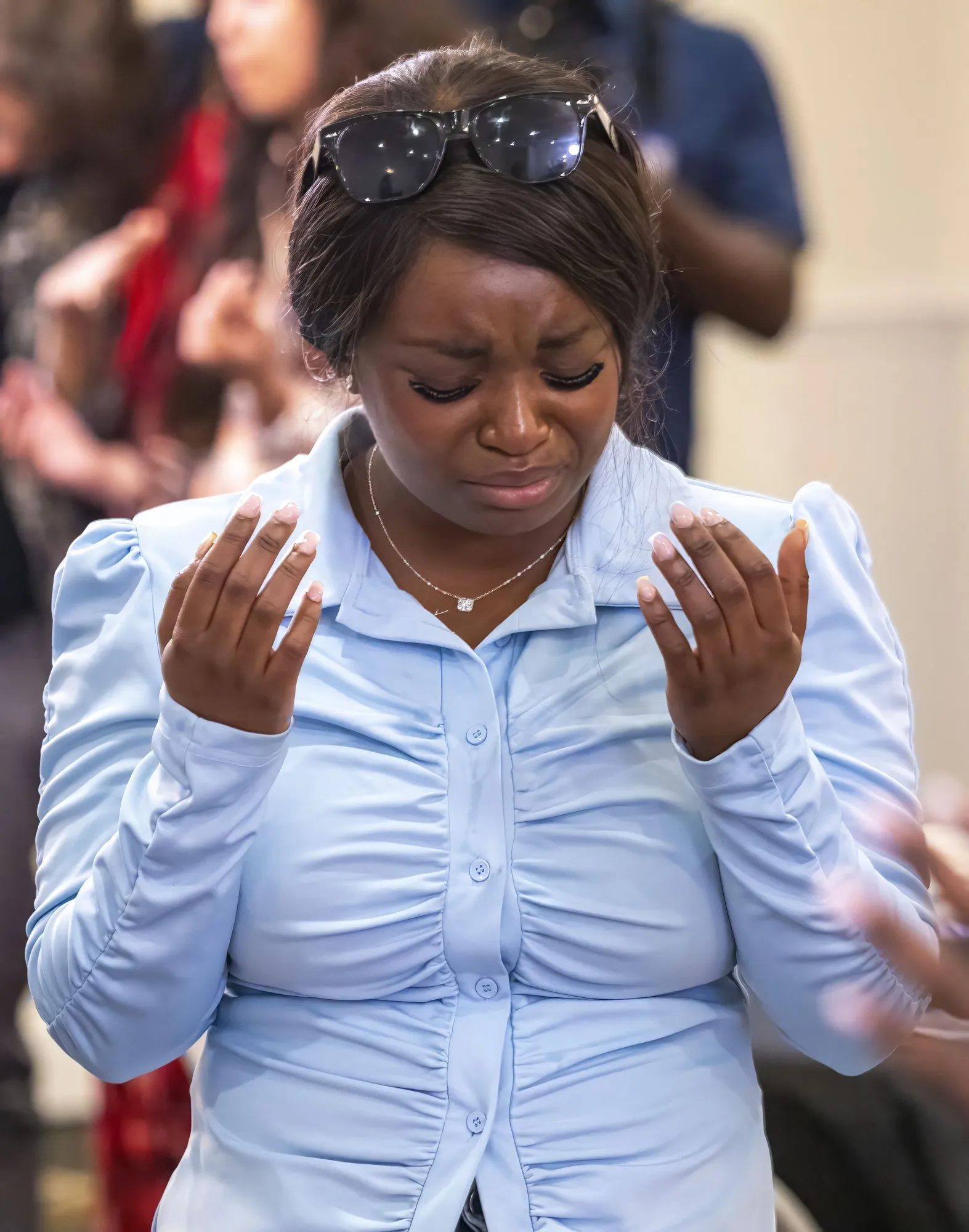 A woman worshipping with her hands open