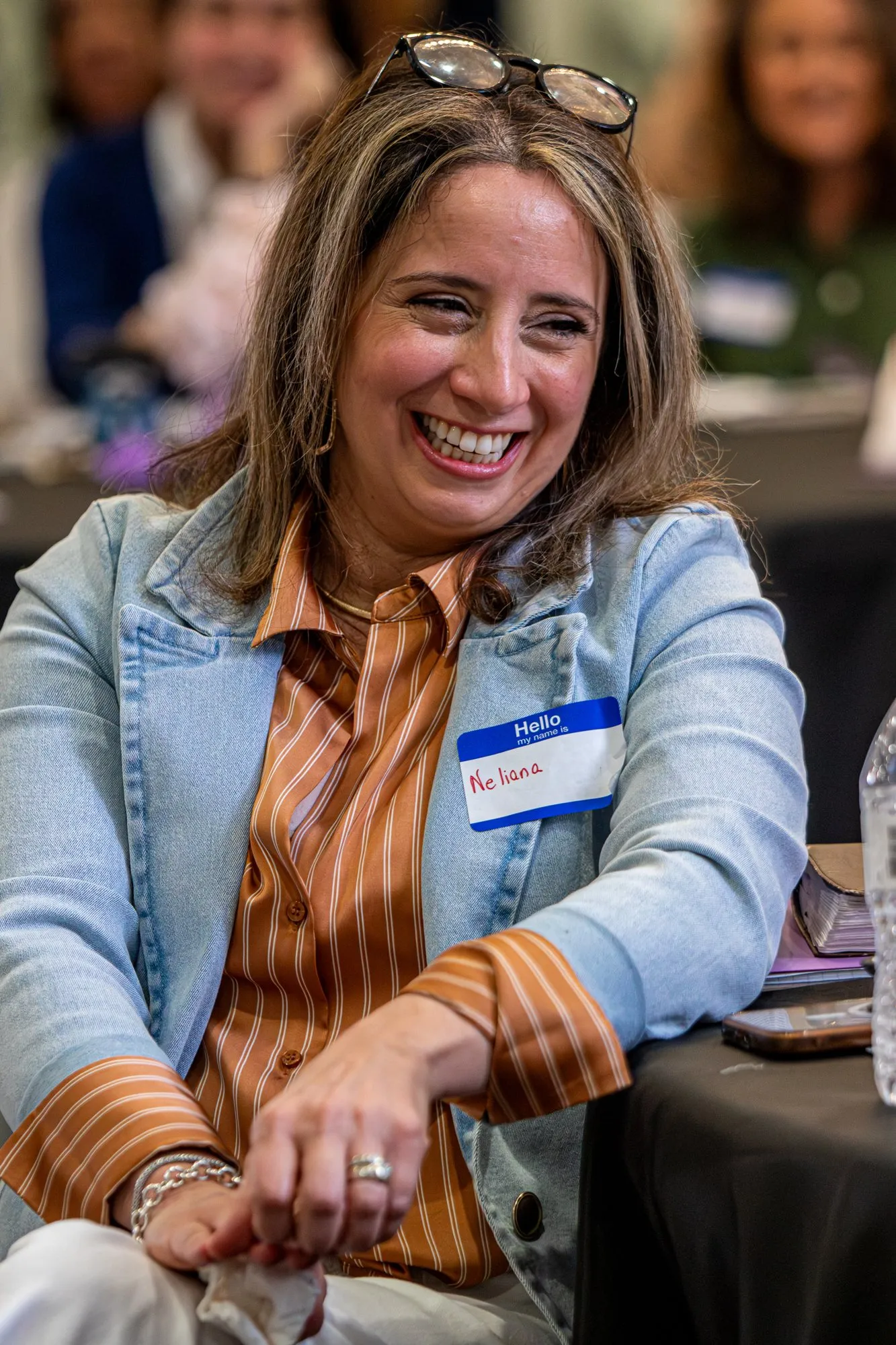 A woman laughing with the women at her table